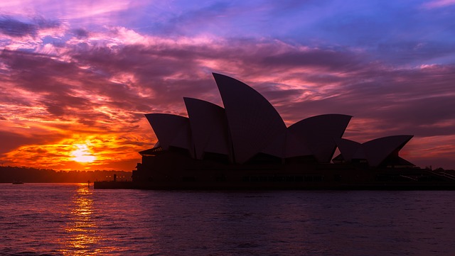Photo of Sydney Opera House over a calm sea.